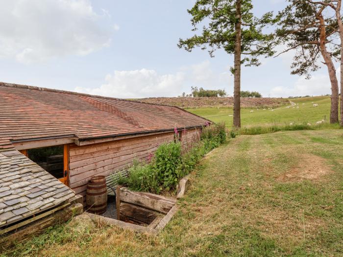 Y Caban in Llangollen, Wrexham. Three double bedrooms. Rustic. Open-plan living space. Pet-friendly.