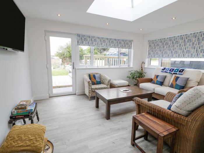 Melody in Cemaes Bay, Anglesey. Close to amenities and beach, sea vistas. Hot tub, family and pets.