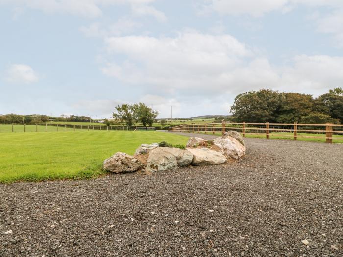 Parys Pod by Amlwch, Anglesey. Studio-style open-plan living, sofa bed, patio, hot tub, rural views.