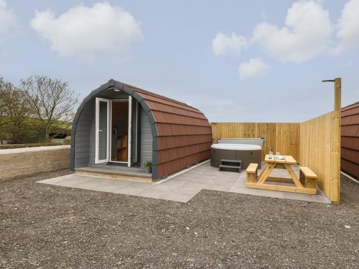 Parys Pod by Amlwch, Anglesey. Studio-style open-plan living, sofa bed, patio, hot tub, rural views.