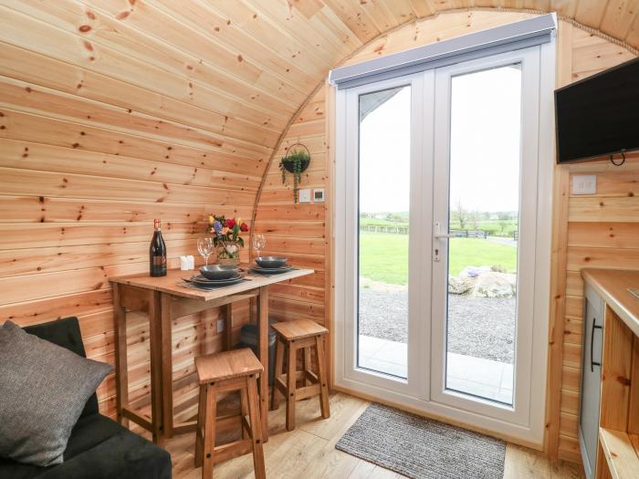 Parys Pod by Amlwch, Anglesey. Studio-style open-plan living, sofa bed, patio, hot tub, rural views.