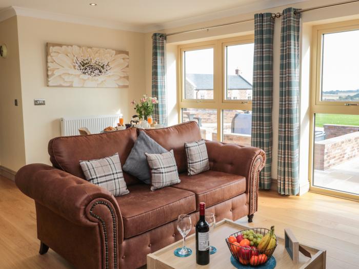 Byre Cottage in Embleton, Northumberland. Single-storey. Child-friendly. Spacious patio with hot tub