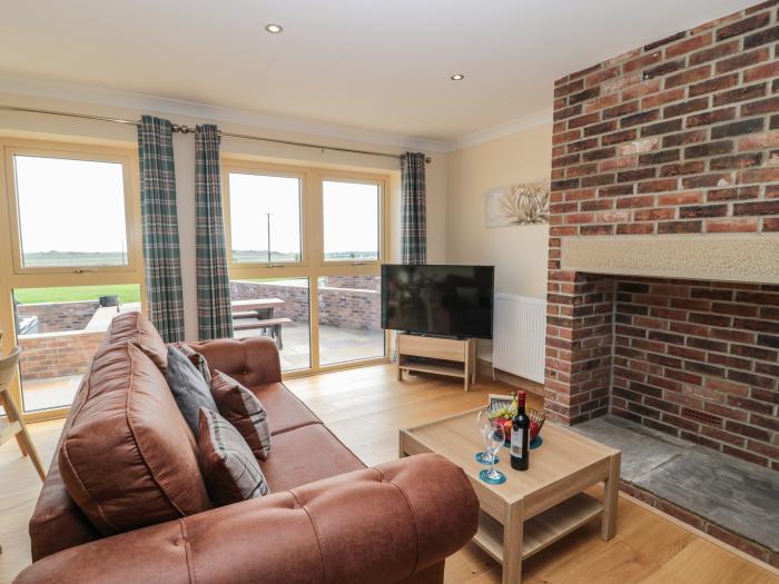 Byre Cottage in Embleton, Northumberland. Single-storey. Child-friendly. Spacious patio with hot tub