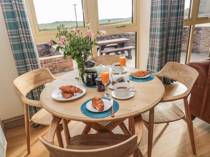 Byre Cottage in Embleton, Northumberland. Single-storey. Child-friendly. Spacious patio with hot tub