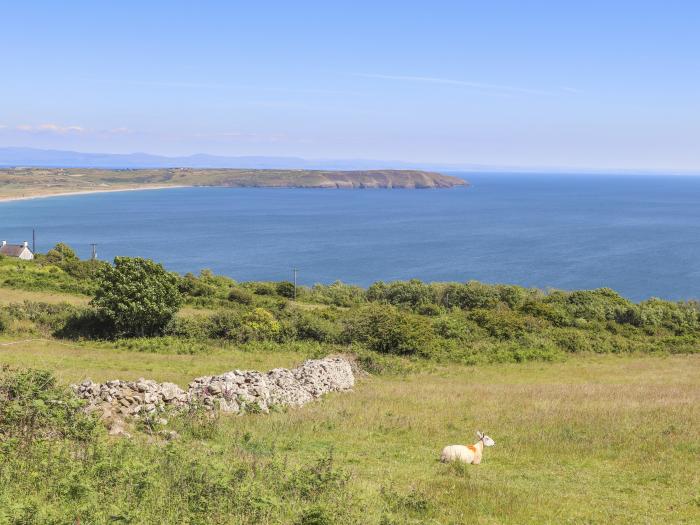 Cowshed in Abersoch, Gwynedd. One bedroom sleeping two guests. Enclosed garden, one pet, near beach.