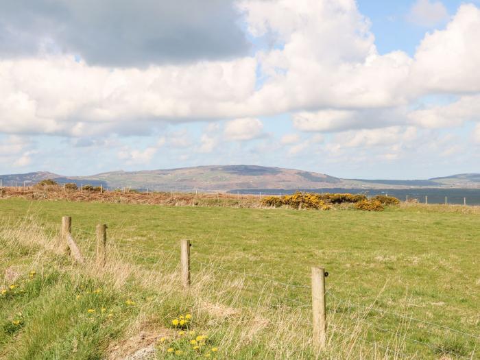 The Farm House near Abersoch, Gwynedd, sleeps seven guests in four bedrooms. Hot tub. Near the beach