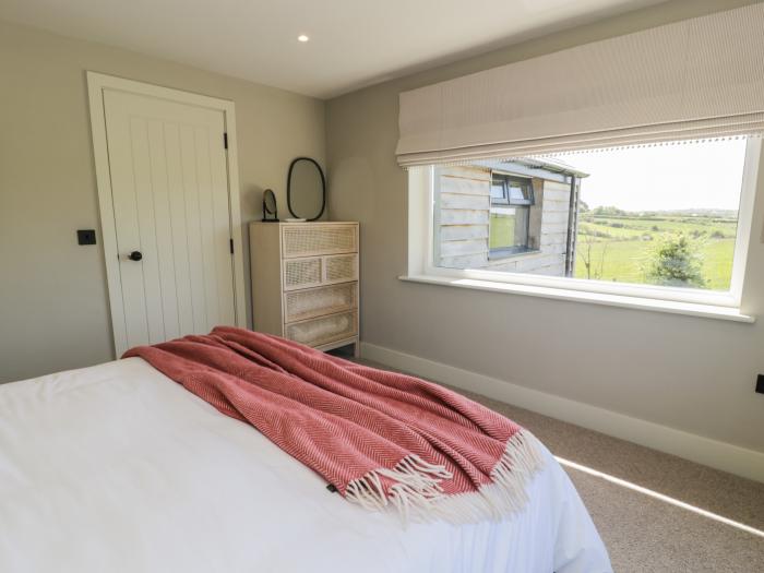 The Farmhouse is in Llanfechell, Anglesey. Luxury home with hot tub and enclosed garden. Near beach.