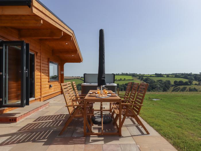 Primrose Lodge in Hittisleigh, Devon. Detached lodge. Open-plan living space with woodburning stove.