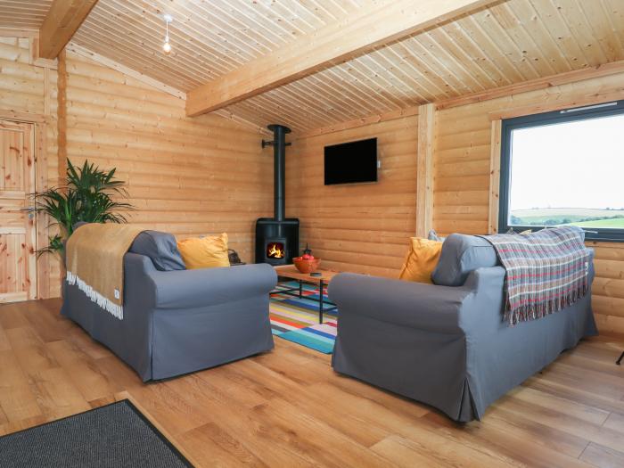 Primrose Lodge in Hittisleigh, Devon. Detached lodge. Open-plan living space with woodburning stove.