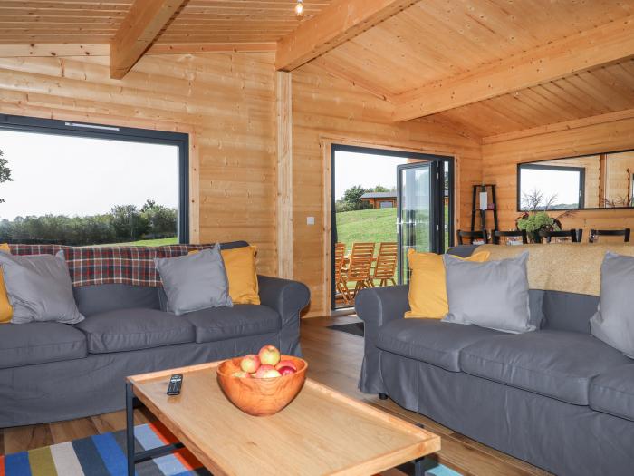 Primrose Lodge in Hittisleigh, Devon. Detached lodge. Open-plan living space with woodburning stove.