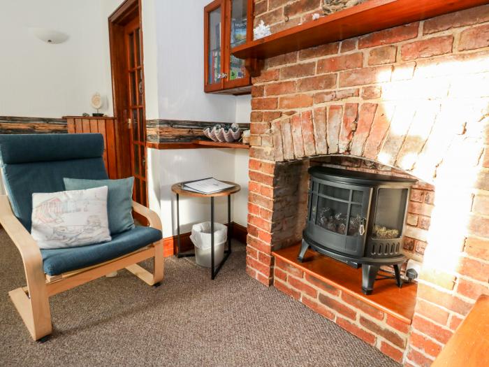 Saddlers Cottage is in Weymouth, Dorset. Two-bedroom home set near amenities and beach. Pet-friendly