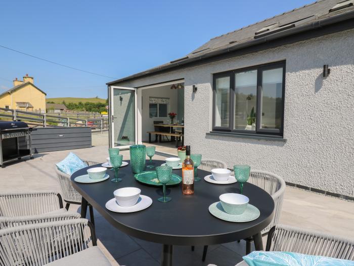 Rhiwmynach is near Aberystwyth, in Ceredigion. Two-bedroom property with woodburning stove. Hot tub.