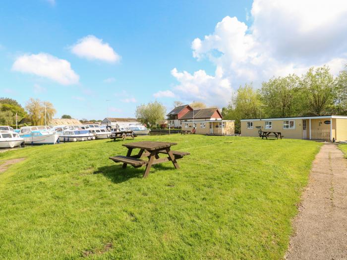 Maud, Stalham, Norfolk. Boathouse on river. Shared garden and private veranda. Off-road parking. TV.