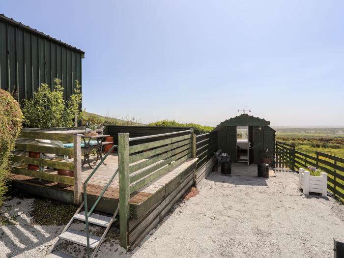 Glamping Pod, Llithfaen, Gwynedd. Ideal for couples. Rural and secluded setting. Decking with seats.