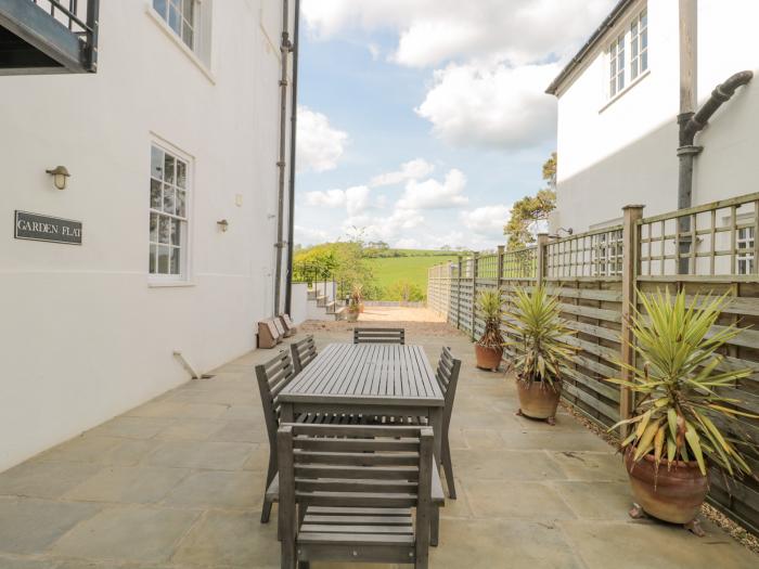 The Garden Flat is in Charmouth, Dorset. Off-road parking. Communal gardens. Close to beach and shop