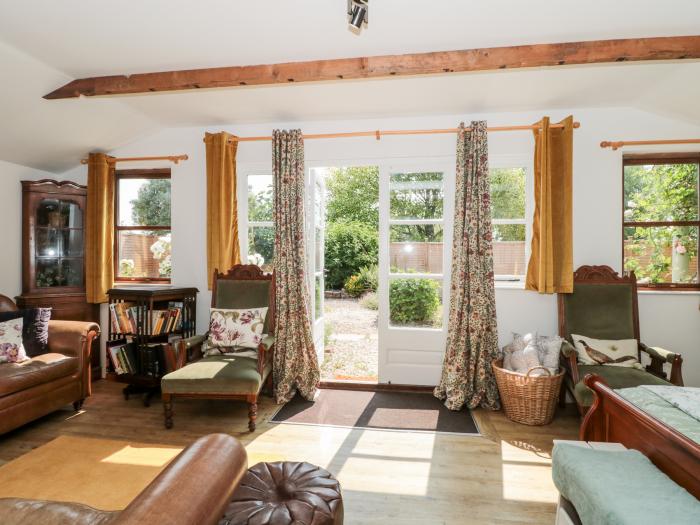 Little Wick is in Lympsham, Somerset. Two-bedroom stable conversion. Enclosed, pretty garden. Family