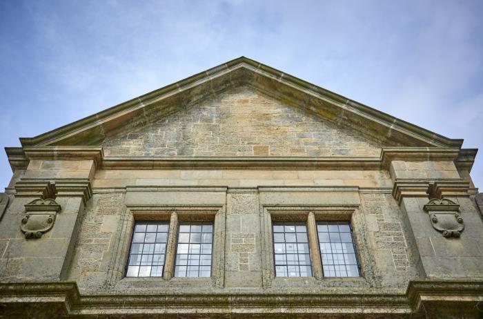 The Smithy is in Humshaugh, Northumberland. Three-bedroom home with woodburning stove. Contemporary.