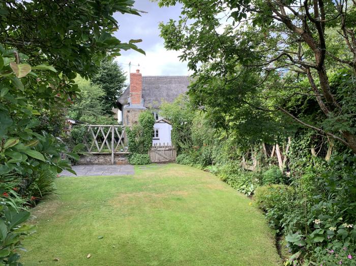 Brewers Cottage rests in Kings Nympton, Devon. Two-bedroom home near a pub. Woodburning stove. Pets.