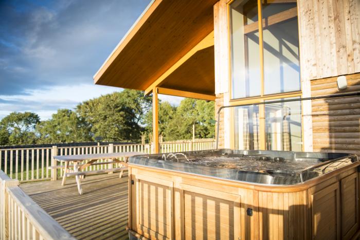 Aurae is in Cawdor, Highlands. Four-bedroom, luxury log cabin with hot tub and sauna. Rural. Family.