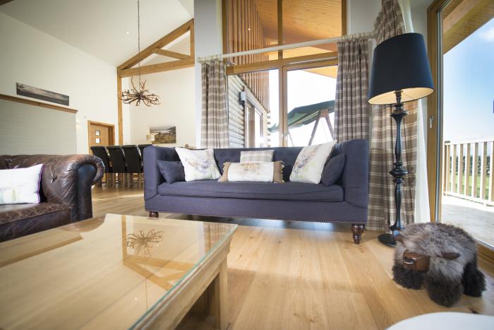 Aurae is in Cawdor, Highlands. Four-bedroom, luxury log cabin with hot tub and sauna. Rural. Family.