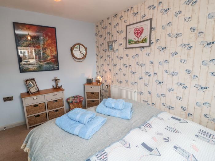 Coast Cottage, Bamburgh, Northumberland. Two-bedroom home resting near the beach and amenities. Pets