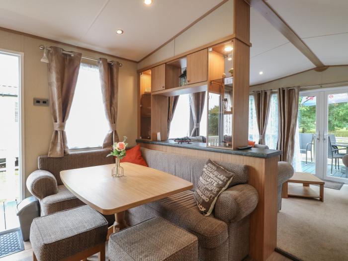 Stanley's Lodge near Belton, Norfolk. Off-road parking. Enclosed decking with furniture. Three beds.