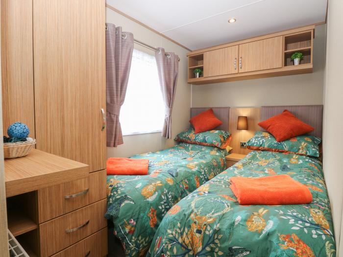 Stanley's Lodge near Belton, Norfolk. Off-road parking. Enclosed decking with furniture. Three beds.