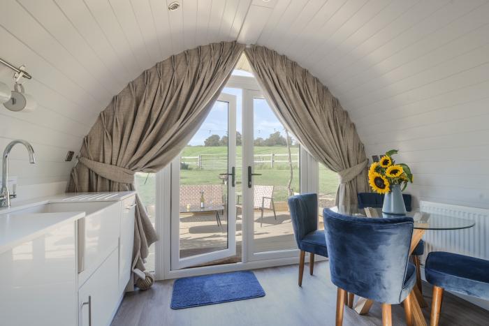 Cedar, located near Charmouth, Dorset. Two-bedroom pod, enjoying rural views. Pet-friendly. Stylish.