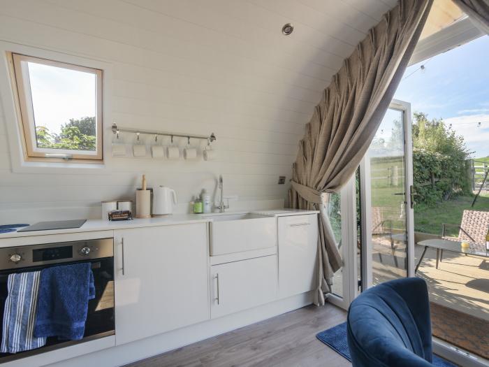 Cedar, located near Charmouth, Dorset. Two-bedroom pod, enjoying rural views. Pet-friendly. Stylish.