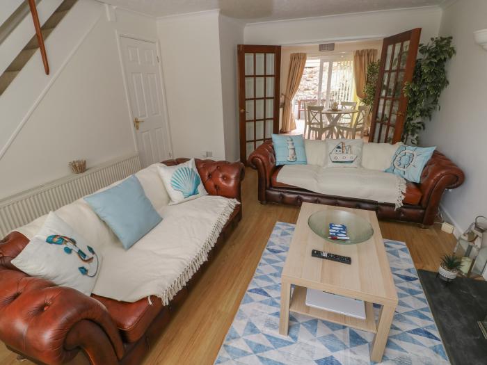 No.7 Merlin Gardens is in Tenby, Pembrokeshire. Two-bedroom chalet with enclosed garden. Near beach.