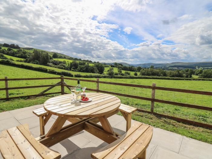 Awel y Bryn, is in Rhayader, Powys. Four-bedroom home enjoying rural views. Enclosed garden. Family.