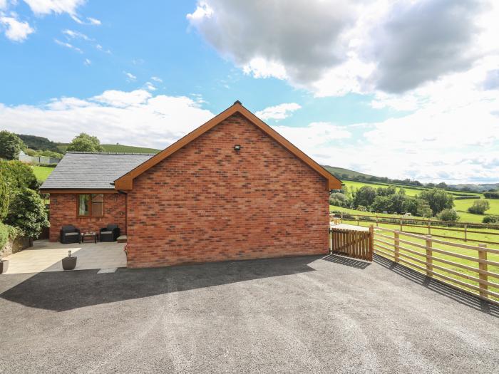 Awel y Bryn, is in Rhayader, Powys. Four-bedroom home enjoying rural views. Enclosed garden. Family.