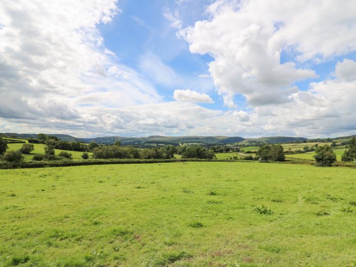 Awel y Bryn, is in Rhayader, Powys. Four-bedroom home enjoying rural views. Enclosed garden. Family.