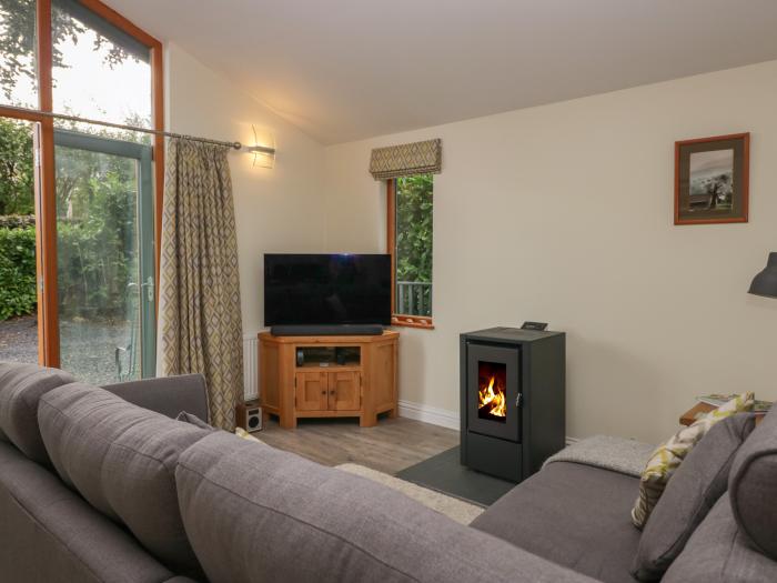 Bay Tree Lodge, Cartmel, Cumbria. Single-storey. Woodburning stove. Decking with furniture. Smart TV