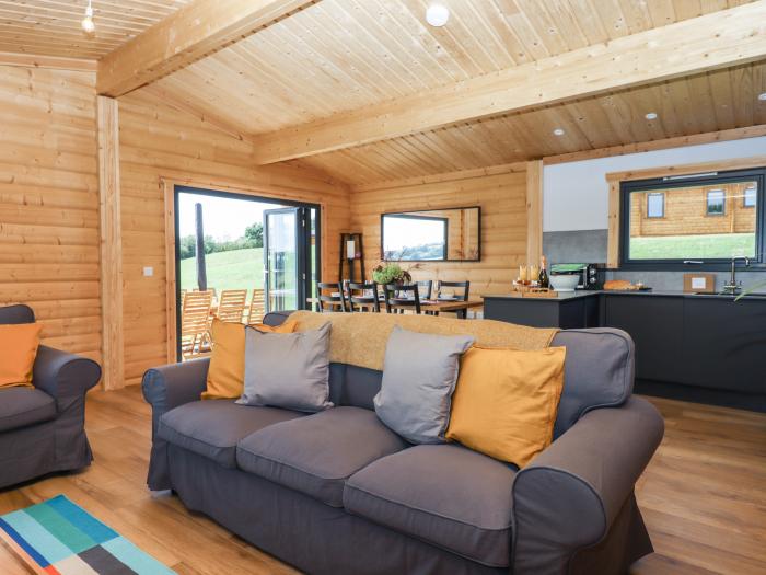 Foxglove Lodge in Hittisleigh, Devon. Detached lodge. Open-plan living space with woodburning stove.