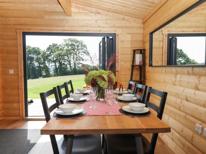 Foxglove Lodge in Hittisleigh, Devon. Detached lodge. Open-plan living space with woodburning stove.