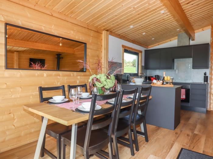 Foxglove Lodge in Hittisleigh, Devon. Detached lodge. Open-plan living space with woodburning stove.