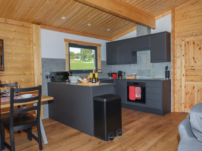 Foxglove Lodge in Hittisleigh, Devon. Detached lodge. Open-plan living space with woodburning stove.