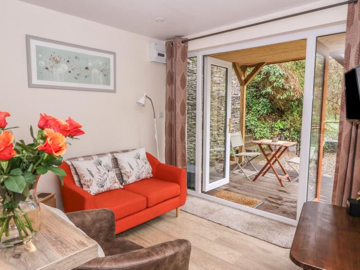 Ty Barddu near Newcastle Emlyn in Carmarthenshire. Elevated, wooden-clad cottage nestled in a valley