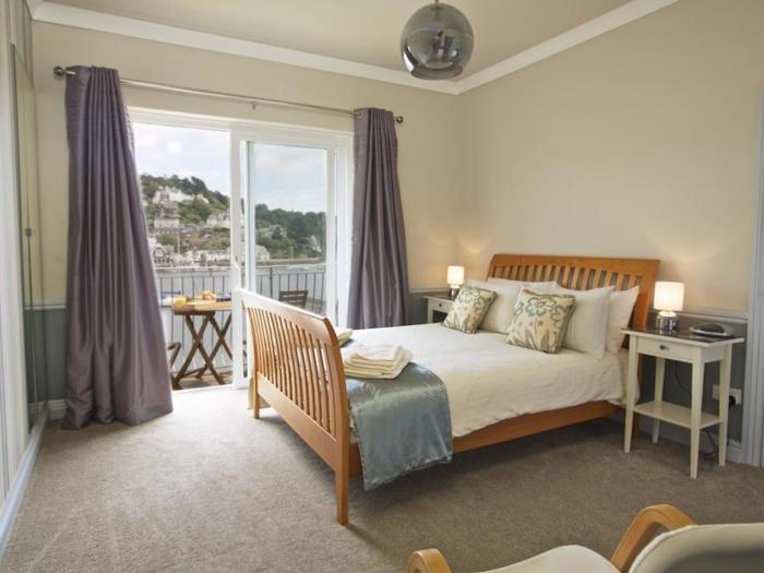 Harbourside, is in Dartmouth, Devon. First-floor apartment with sea views. Near amenities and beach.