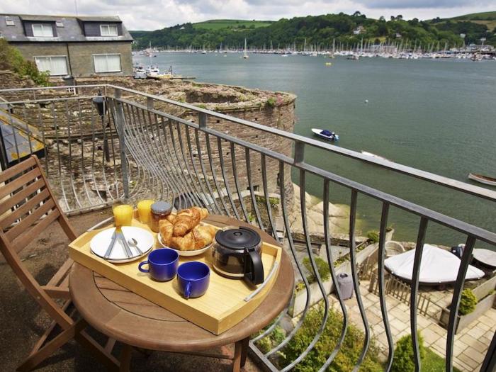 Harbourside, is in Dartmouth, Devon. First-floor apartment with sea views. Near amenities and beach.