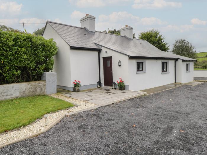 Kate's Cottage rests near Ballintubber, County Mayo. Two-bedroom home with enclosed garden. Stylish.