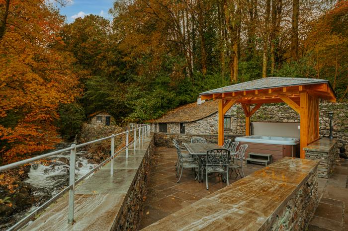 Gate House, is in Coniston, Cumbria. Four-bedroom home with stunning riverside views. Hot tub. Pets.